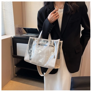 Close-up of a transparent PVC tote bag with white inner pouch and offbetter logo detail