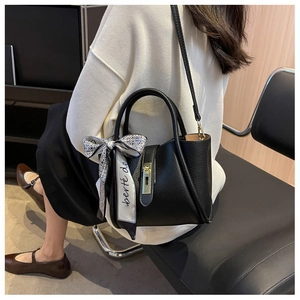 Black lychee leather bucket bag with silk scarf and adjustable crossbody strap