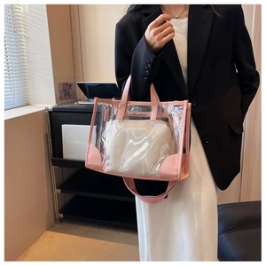 Detailed macro view of a pink transparent PVC tote bag featuring a white inner pouch