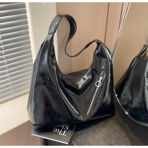 Detail of black Hobo bag with glossy crinkle texture and minimalist ring zipper puller