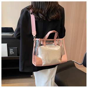 Detail of pink PVC tote bag with canvas strap and branded inner pouch in office setting