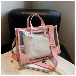 Detail of pink transparent PVC tote bag with white inner pouch and wide shoulder strap