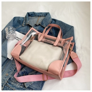Detail of pink transparent PVC jelly tote bag with soft inner pouch and gold hardware