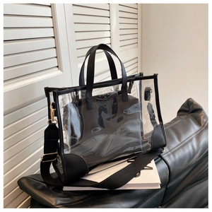 Detail of transparent PVC tote with black leather trim, inner pouch and gold hardware