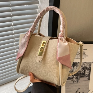 Beige pebble leather bucket bag with silk scarf handle and elegant gold turn-lock