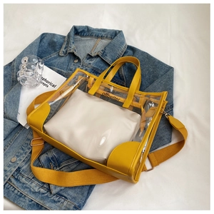 Detail of yellow transparent PVC tote with white inner pouch and woven shoulder strap
