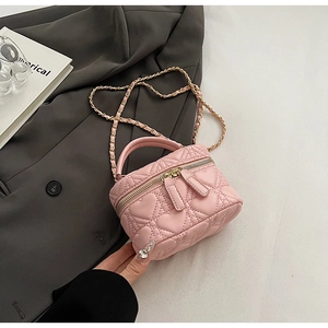 Detailed close-up of pink heart-quilted mini box bag with gold-tone hardware and chain