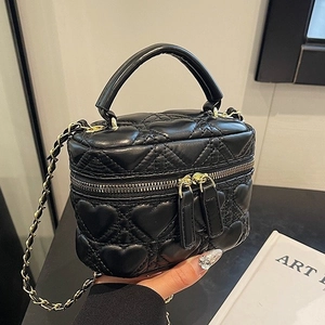 Mini heart-quilted black vanity case with gold hardware and chain strap