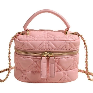 Pink heart-quilted leather vanity bag with golden chain strap and top handle
