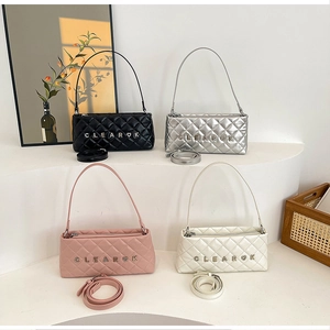 Detail of four quilted chain bags in black, silver, pink and beige with metal logo