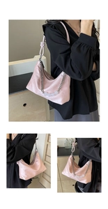 Detail of pink satin underarm bag featuring jade-style beads and braided rope strap