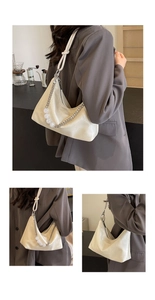 Detail of hobo shoulder bag featuring beaded chain strap and beige leather texture