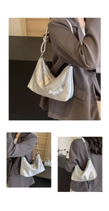 Detail of silver metallic underarm bag with decorative beaded chain and leather strap