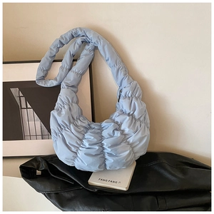 Detail der hellblauen Croissant-Tasche mit geraffter Nylon-Textur und Trageriemen