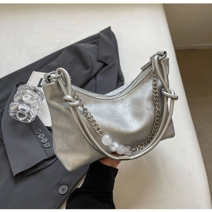 Detail of silver metallic hobo bag featuring thick chain with clear acrylic bead accents