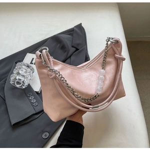 Close-up of pink crescent shoulder bag with silver chain and transparent bead details