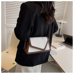 Chic white croc-embossed shoulder bag with brown leather trim shown on model
