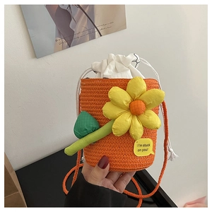 Detail of orange woven bucket bag with large sunflower design and white drawstring inner bag