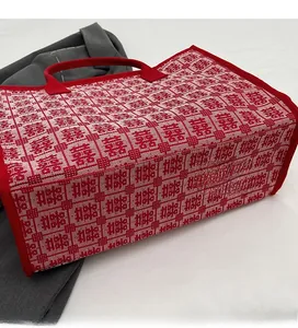 Close-up of wedding tote bag featuring red and white Xi character patterns with neat stitching