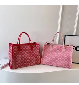 Detail of red and pink bridal tote bags featuring traditional double happiness patterns