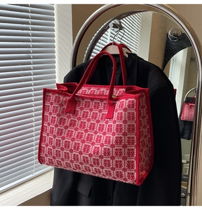 Detailed view of red wedding tote bag with white Xi character jacquard pattern