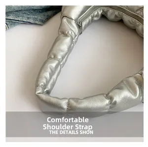 Detail of soft padded shoulder strap and silver lychee texture on cloud underarm bag