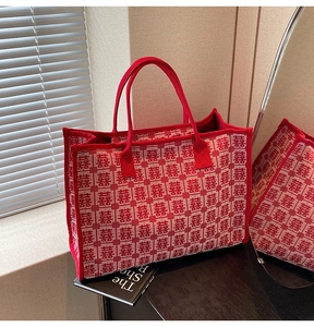 Detailed view of red wedding tote bag featuring woven traditional double happiness pattern