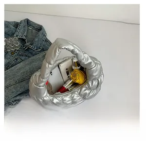 Top view of silver cloud bag interior showing capacity for phone, umbrella and cosmetics