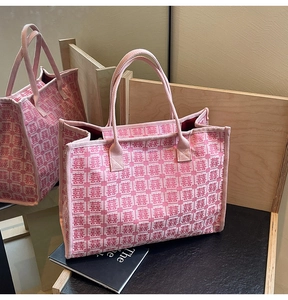 Detail view of woven pink wedding tote bag with traditional red Double Happiness pattern
