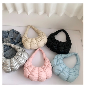 Detailed top view of pleated dumpling bags in silver, cream, black, pink, and blue colors