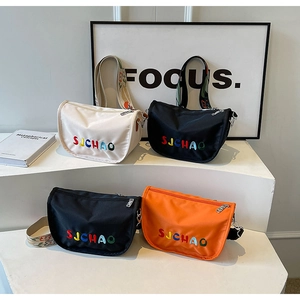 Nylon crescent crossbody bag detail with floral strap and colorful Suchao embroidery
