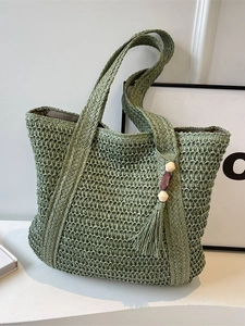 Straw tote bag in green with fringe tassel and wood beads for summer beach look