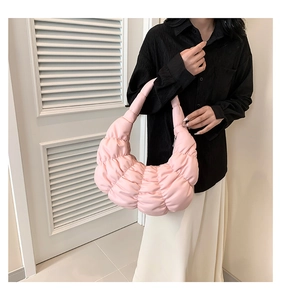 Detailed view of lightweight pink ruched hobo bag shown in a stylish crossbody carry style