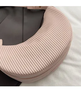 Detailed macro view of soft pleated leather texture on a pink dumpling handbag