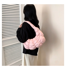 Detail of pink quilted cloud hobo bag showing the puffy texture and soft shoulder strap