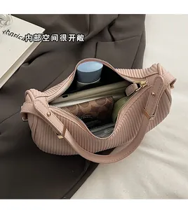 Detailed interior of the pink pleated dumpling bag showing spacious capacity and storage