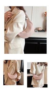 Detail view of pink pleated crescent bag showing texture and stylish underarm carry