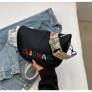 Detail of black nylon crossbody bag with colorful SUCHAO embroidery and wide jacquard strap