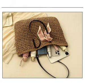 Interior view showing the large capacity of the woven straw tote bag with summer essentials