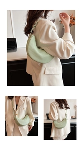 Detail of mint green pleated crescent bag showing shoulder and crossbody styling