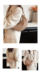 Detailed close-up of beige crescent bag featuring vertical pleated texture and adjustable strap