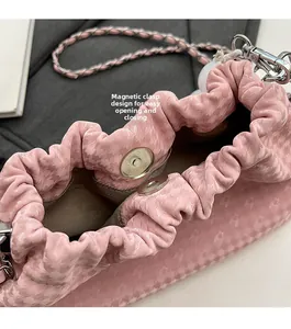 Pink pleated cloud bag detail with magnetic buckle closure and star texture chain strap