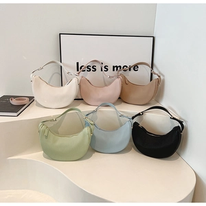 Collection of pleated hobo bags in assorted macaron colors on a minimalist display