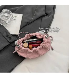 Pink pleated cloud bag showing large interior capacity for phone and cosmetics