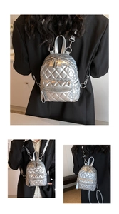 Macro view of metallic silver quilted mini backpack featuring shiny rhombus texture