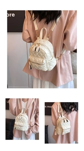 Detailed view of a white quilted mini backpack featuring gold zippers and chain straps