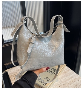 Detail of silver crackle texture hobo bag with adjustable strap and metallic finish