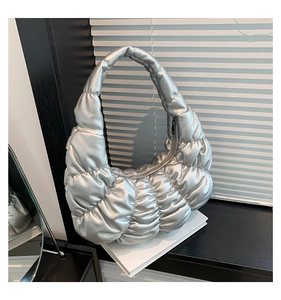 Close-up of metallic silver quilted puffy hobo bag with a stylish pleated bubble texture