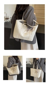Detail of cream woven tote bag featuring geometric patterned silk scarf and twin handles