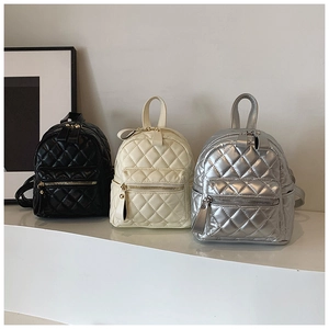 Detailed comparison of mini quilted backpacks in classic black, cream white, and metallic silver